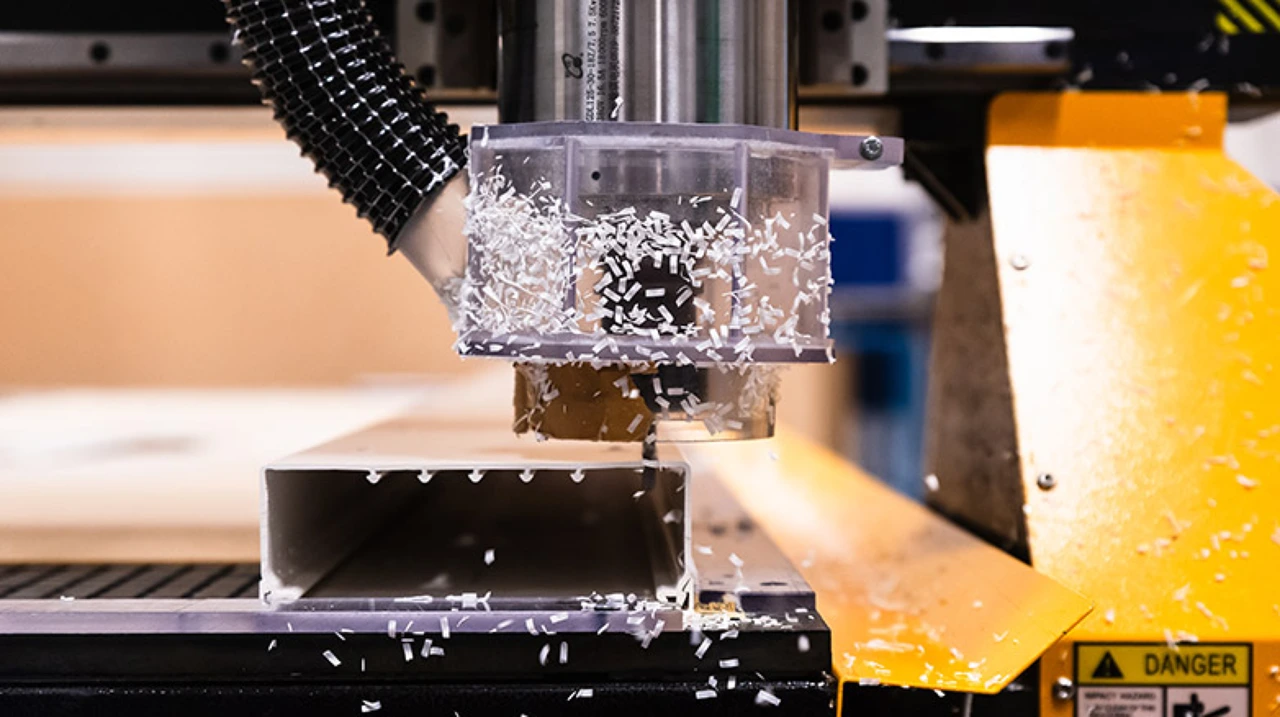 A piece of plastic being CNC cut to size.